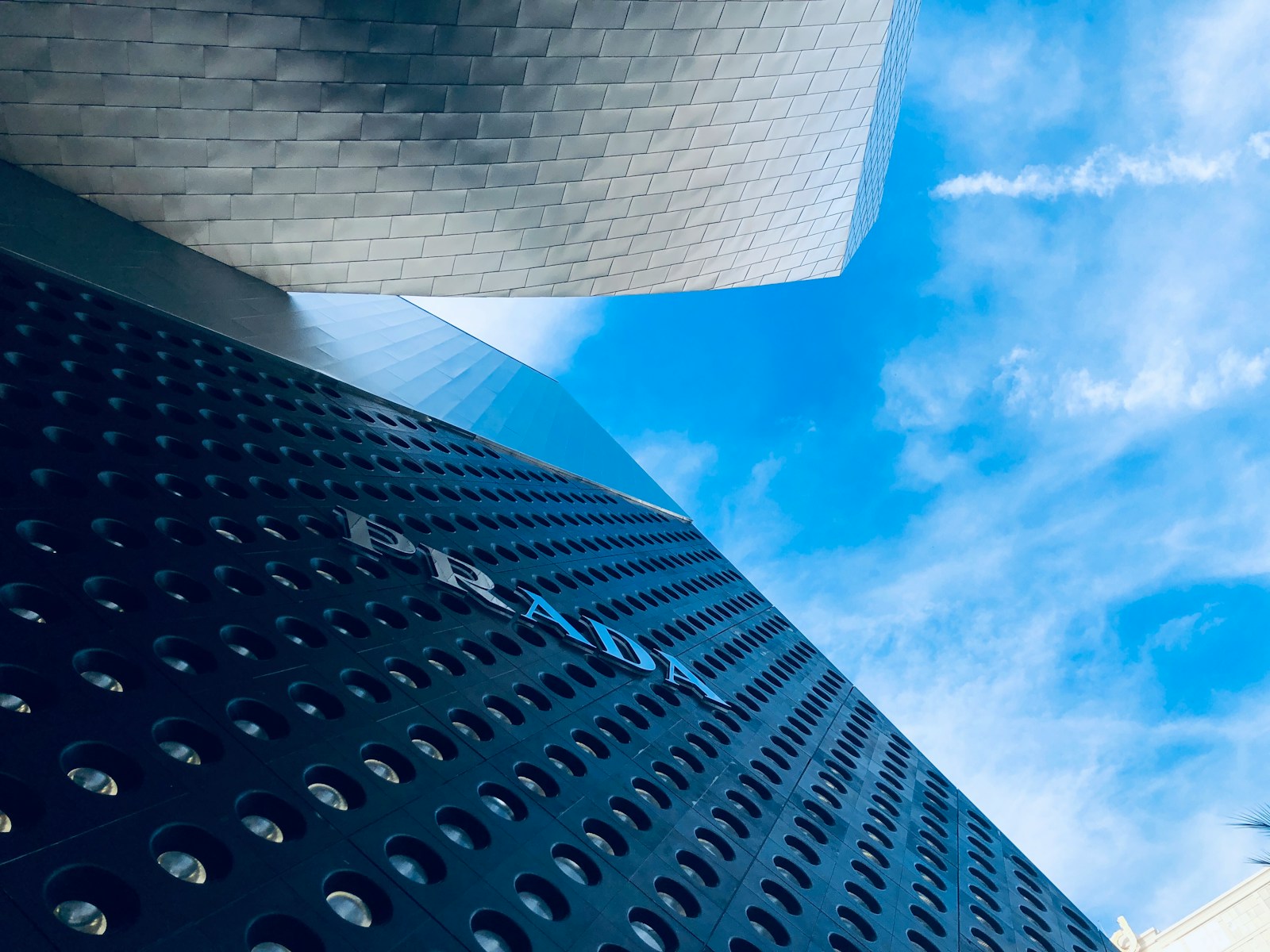 white clouds over gray building