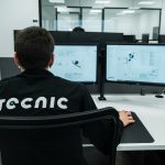 A person works on a computer in an office.